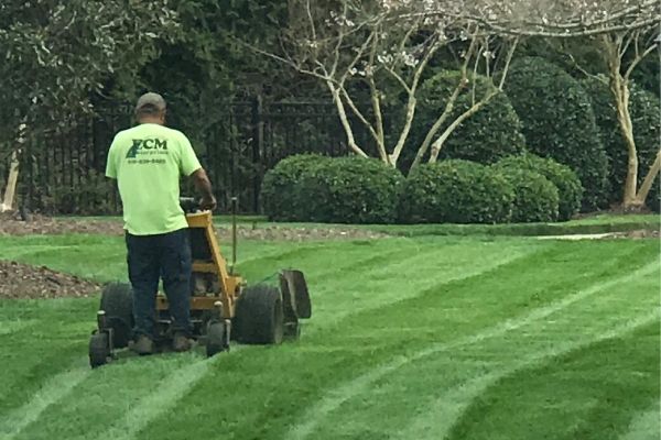 ECM employee mowing a customer's lawn.