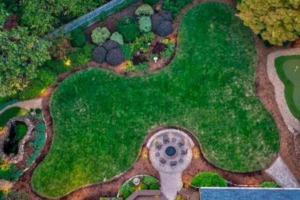 Aerial view of a dark green lawn surrounded by landscaping.