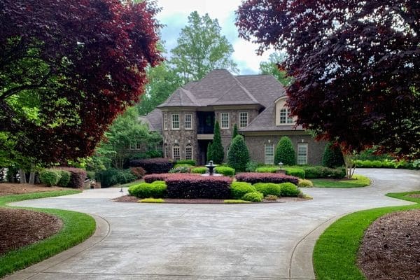 Estate with detailed landscaping requiring professional year-round maintenance.