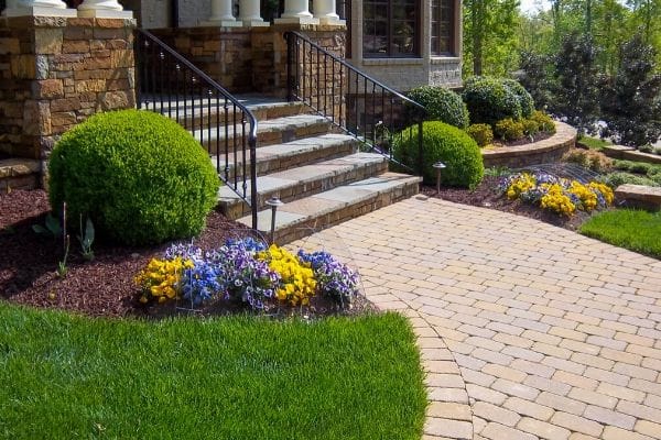 Seasonal flowers installed by ECM Landscaping and Lawn Care at the entrance of a customer's home.